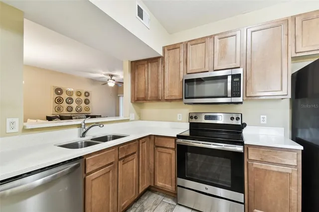 a kitchen with a refrigerator sink and microwave