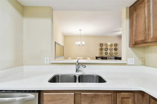 a view of a dining room with furniture and a chandelier