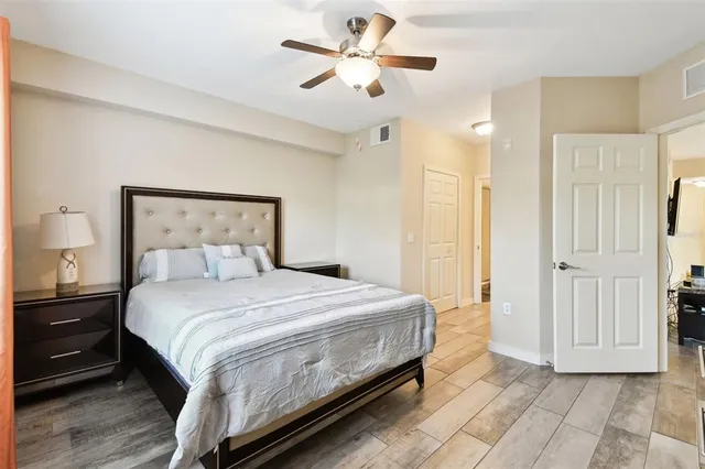 a view of a bedroom with bed and wooden floor