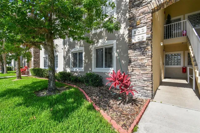 a view of a house with potted plants