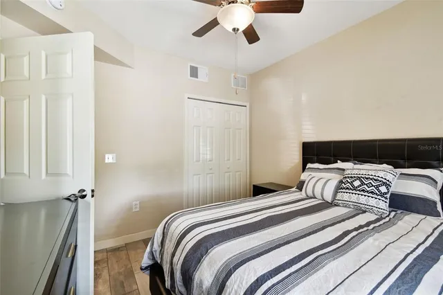a view of a yard in front of a house with a large tree