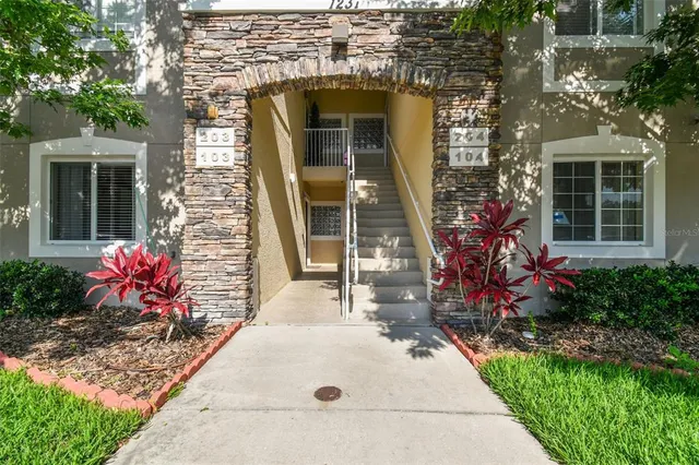 a kitchen with sink a microwave a stove and cabinets
