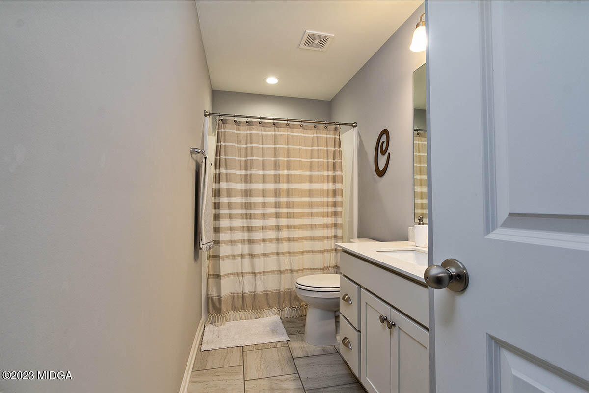 4227 Cornwall Drive Forsyth, GA 31029 - Photo 16 of 27 a bathroom with a toilet a sink and shower