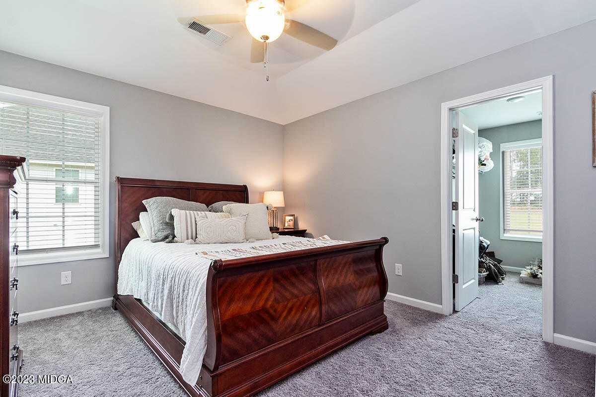 4227 Cornwall Drive Forsyth, GA 31029 - Photo 17 of 27 a bedroom with a bed and a chandelier