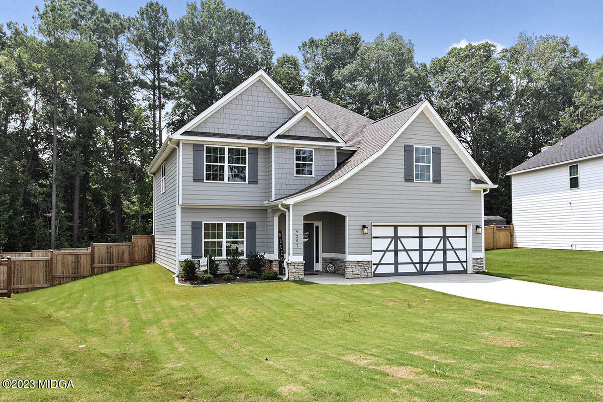 4227 Cornwall Drive Forsyth, GA 31029 - Photo 2 of 27 a front view of a house with a garden and plants
