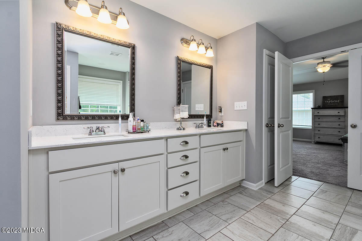 4227 Cornwall Drive Forsyth, GA 31029 - Photo 22 of 27 a spacious bathroom with a double vanity sink and a mirror