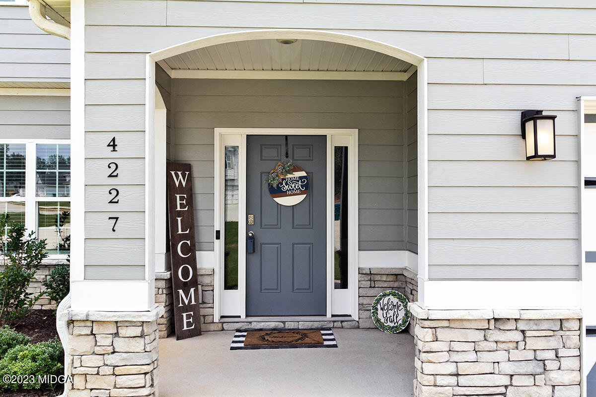 4227 Cornwall Drive Forsyth, GA 31029 - Photo 3 of 27 a front view of a house with a garden
