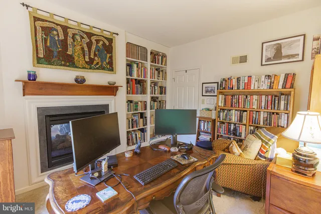 a work room with furniture and a bookshelf