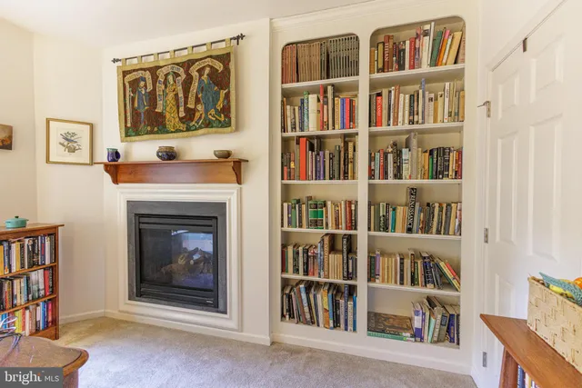 a living room with a book shelf and a book shelf
