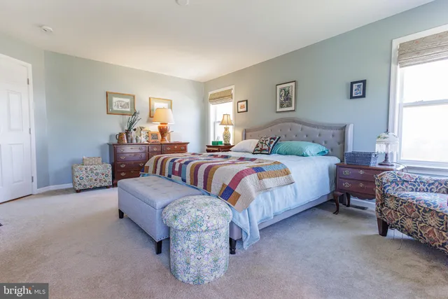 a bedroom with a bed and a couch