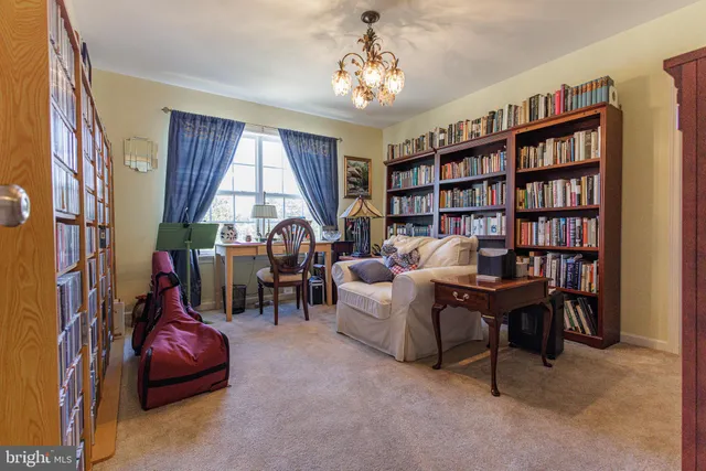 a view of a livingroom with furniture and a bookshelf