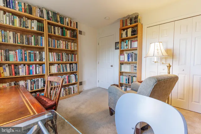 a view of a livingroom with furniture and bookshelf