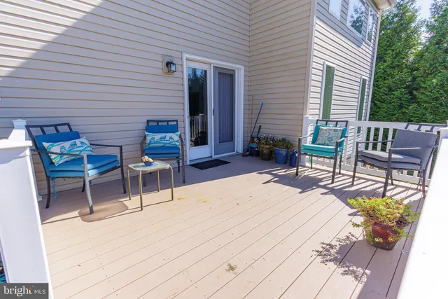 a balcony with table and chairs