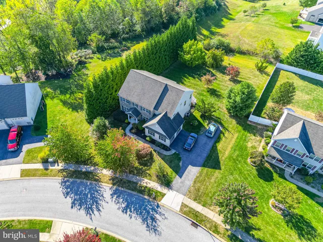 an aerial view of a house with a garden and swimming pool