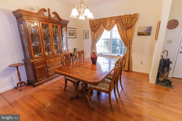 a dining room with furniture window and wooden floor