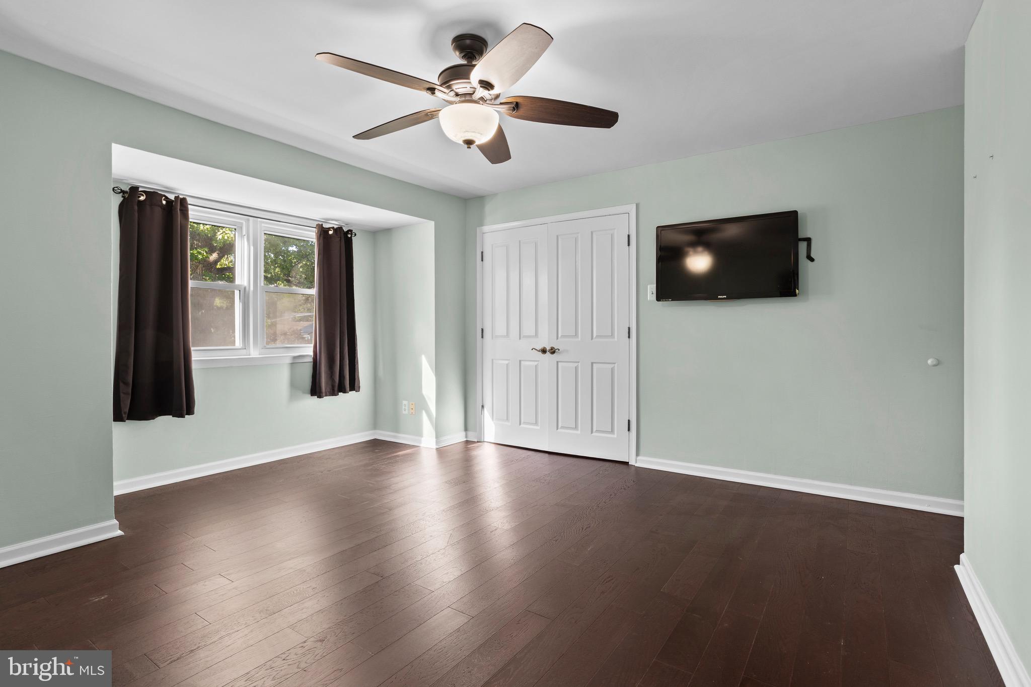 1309 Grace Road Swarthmore, PA 19081 - Photo 17 of 33 a view of an empty room with wooden floor and a ceiling fan