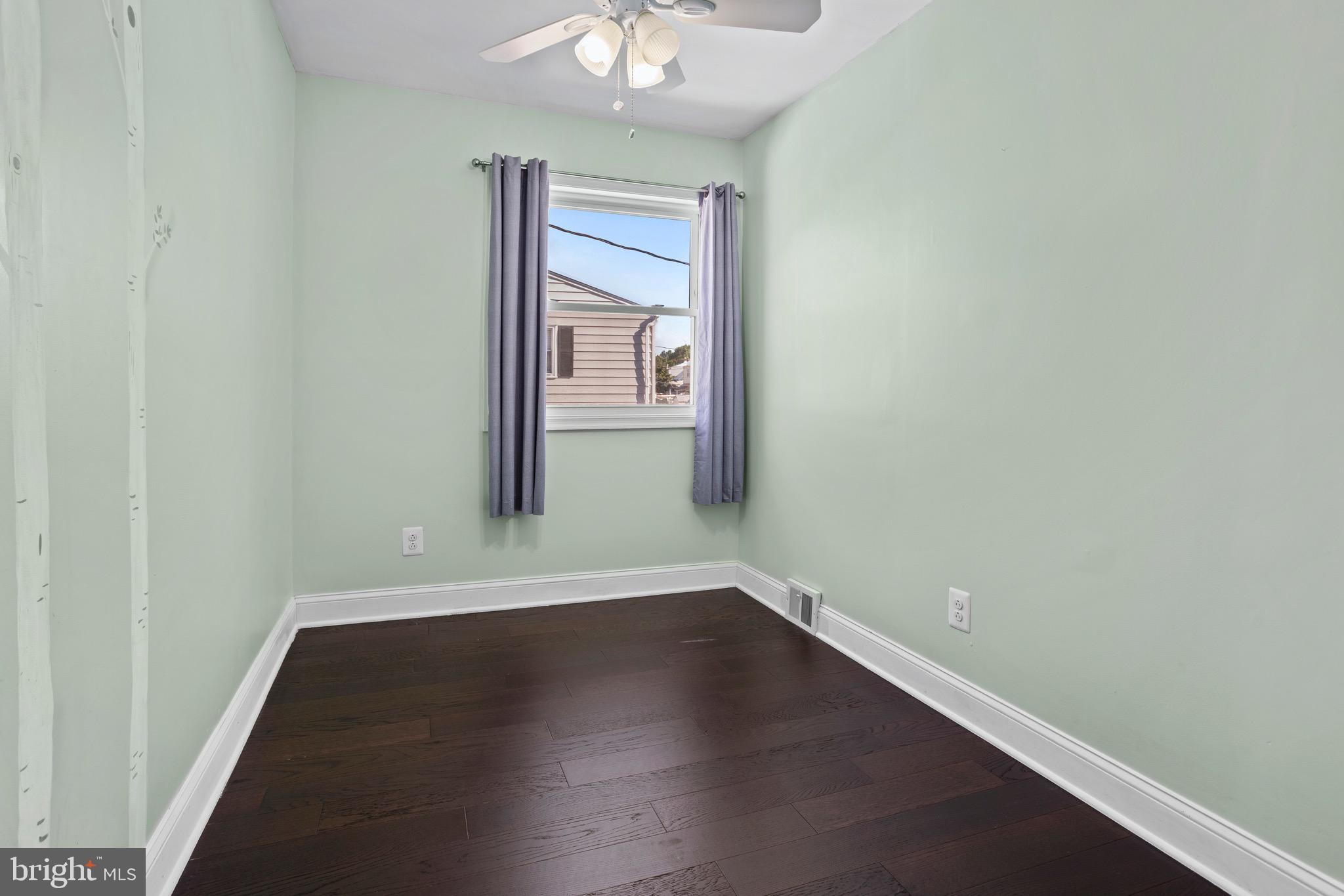 1309 Grace Road Swarthmore, PA 19081 - Photo 20 of 33 an empty room with wooden floor and windows