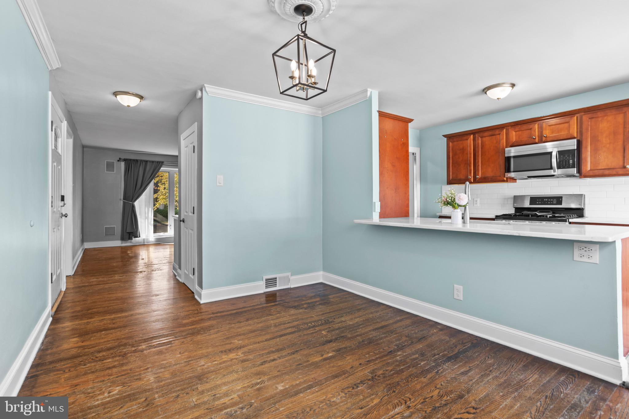 1309 Grace Road Swarthmore, PA 19081 - Photo 8 of 33 a view of a kitchen with a stove wooden floor and a window