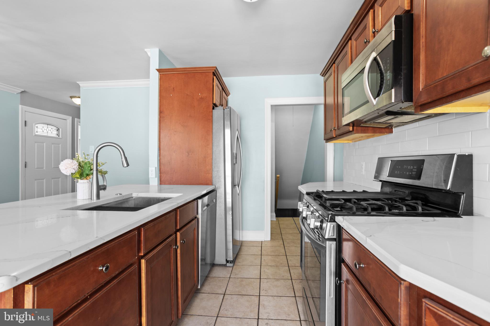 1309 Grace Road Swarthmore, PA 19081 - Photo 10 of 33 a kitchen with stainless steel appliances granite countertop a sink stove and cabinets