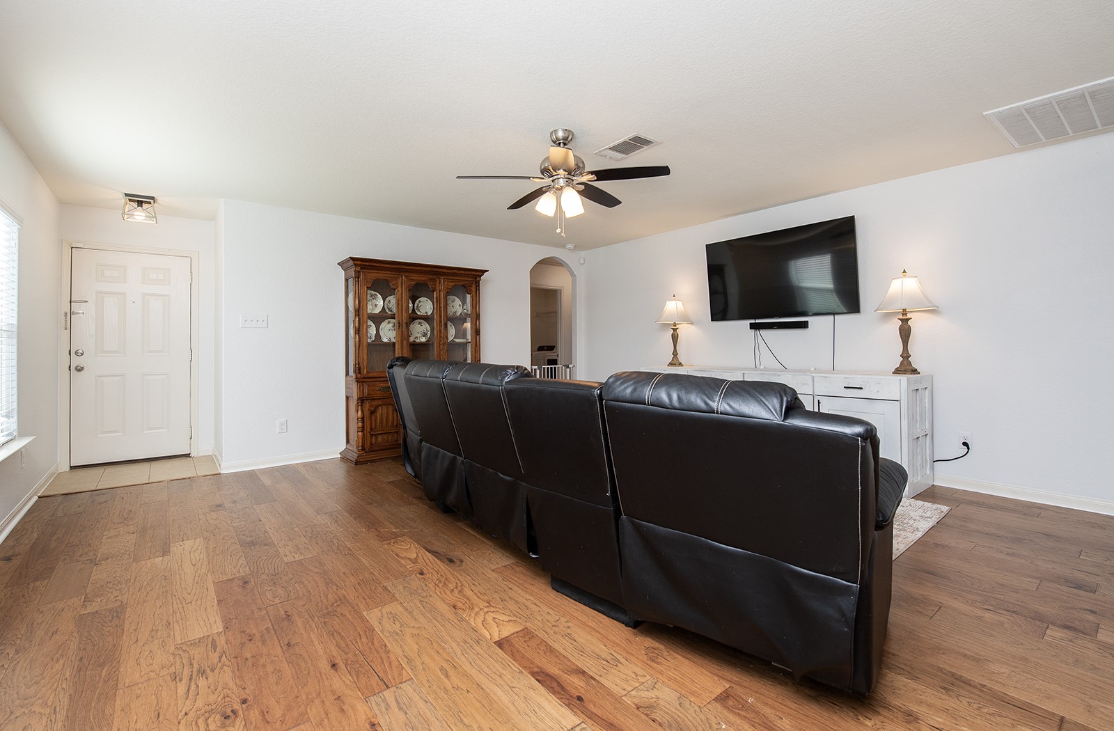 216 Millers Loop Jarrell, TX 76537 - Photo 5 of 31 Living area featuring arched walkways, hard wood flooring, and ceiling fan