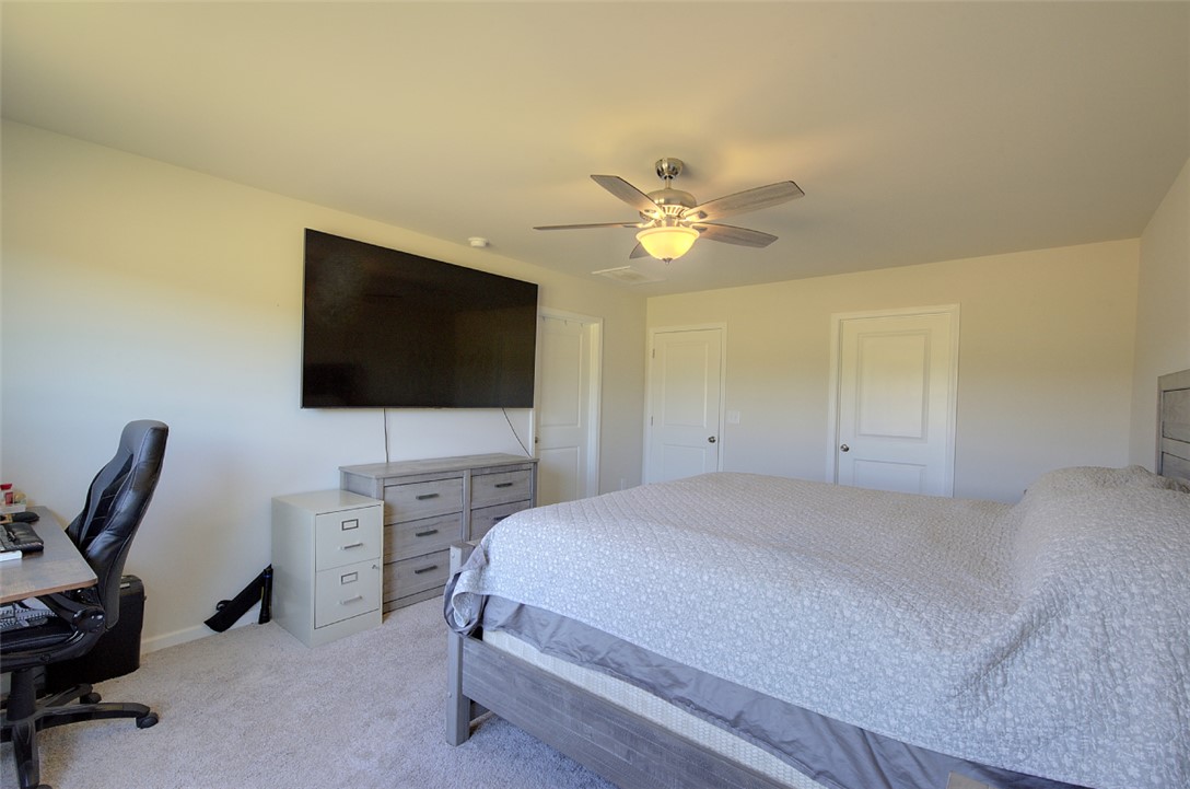 408 Chadwick Lane Walhalla, SC 29691 - Photo 14 of 44 Relax in this well-lit bedroom featuring soft carpeting and a convenient ceiling fan.