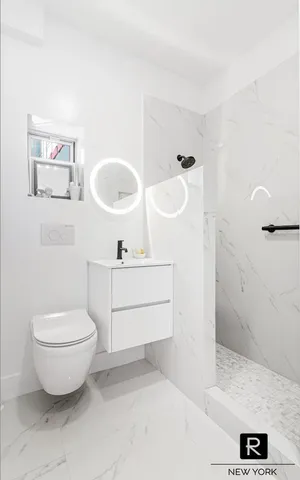a bathroom with a sink toilet and shower