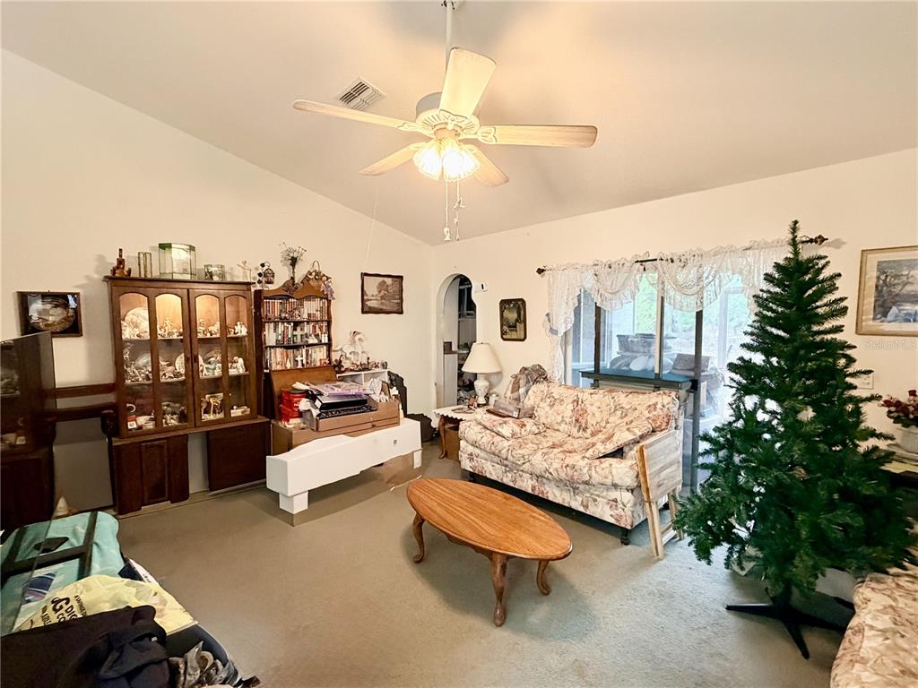 14030 Hexam Road Brooksville, FL 34613 - Photo 11 of 18 a living room with furniture and a chandelier