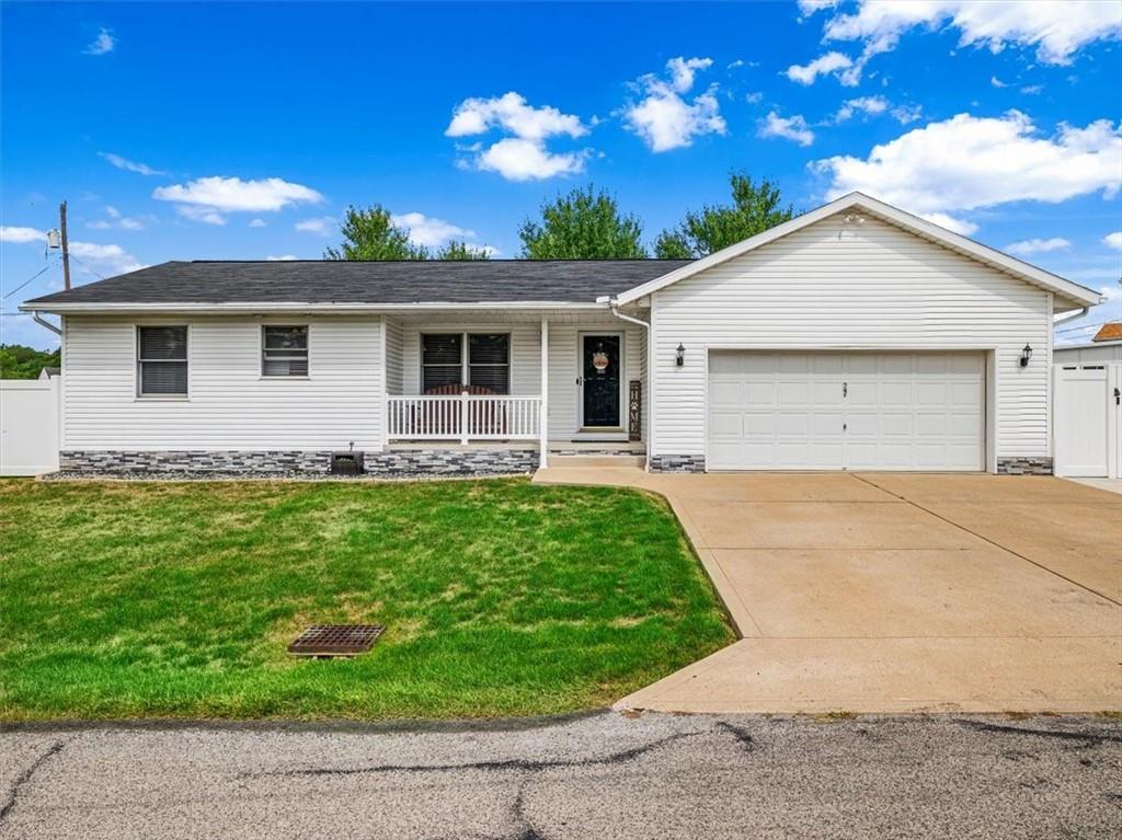 a view of a house with yard and green space