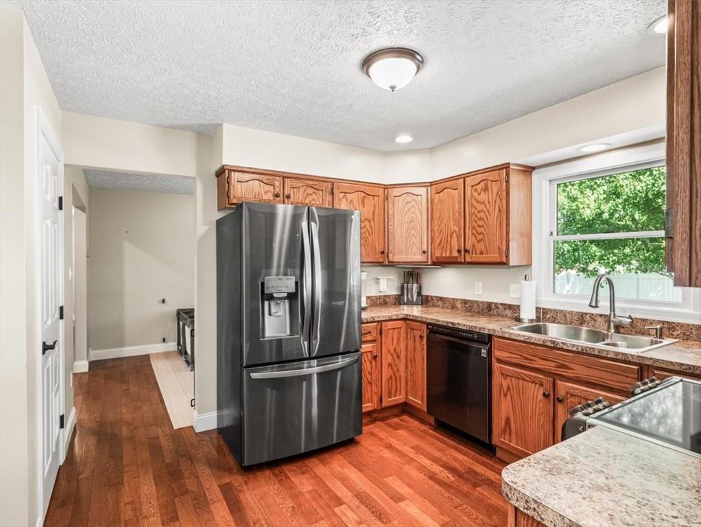 27 Spring Valley Street Slovan, PA 15078 - Photo 11 of 30 a kitchen with stainless steel appliances granite countertop a refrigerator a sink dishwasher a stove with wooden floor and cabinets