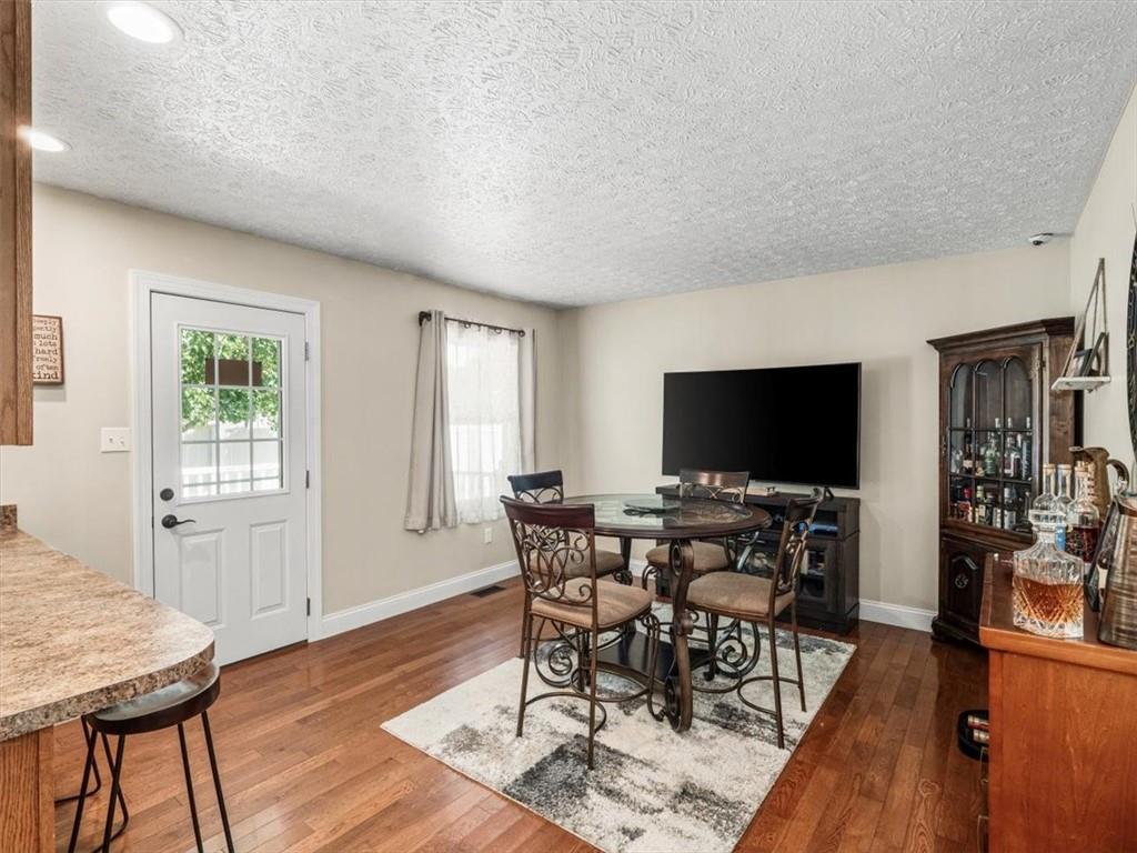 27 Spring Valley Street Slovan, PA 15078 - Photo 12 of 30 a view of a livingroom with furniture a flat screen tv and wooden floor