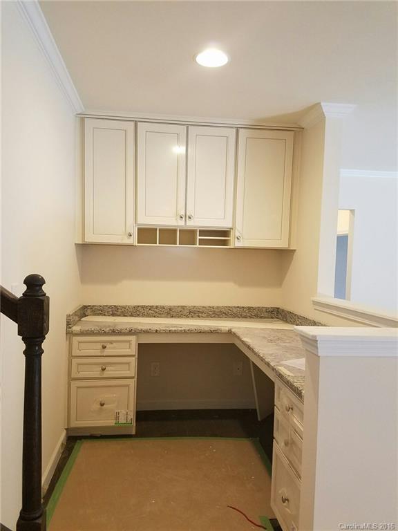 7010 Fallondale Road, Unit MB528 Waxhaw, NC 28173 - Photo 9 of 16 a kitchen with granite countertop a sink and a stove