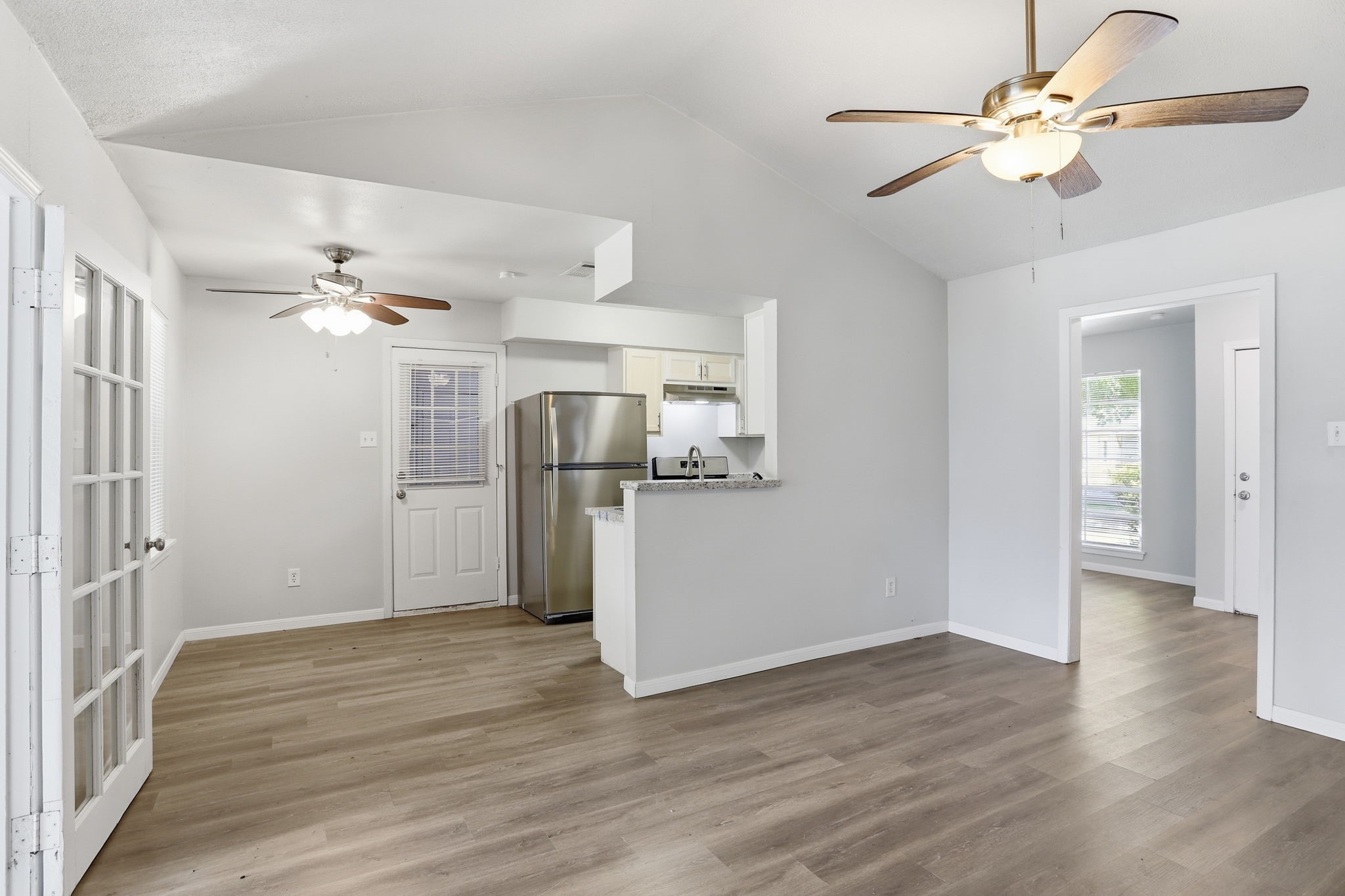 5242 Grace Point Lane Houston, TX 77048 - Photo 13 of 38 a view of a kitchen with a dishwasher cabinets and wooden floor