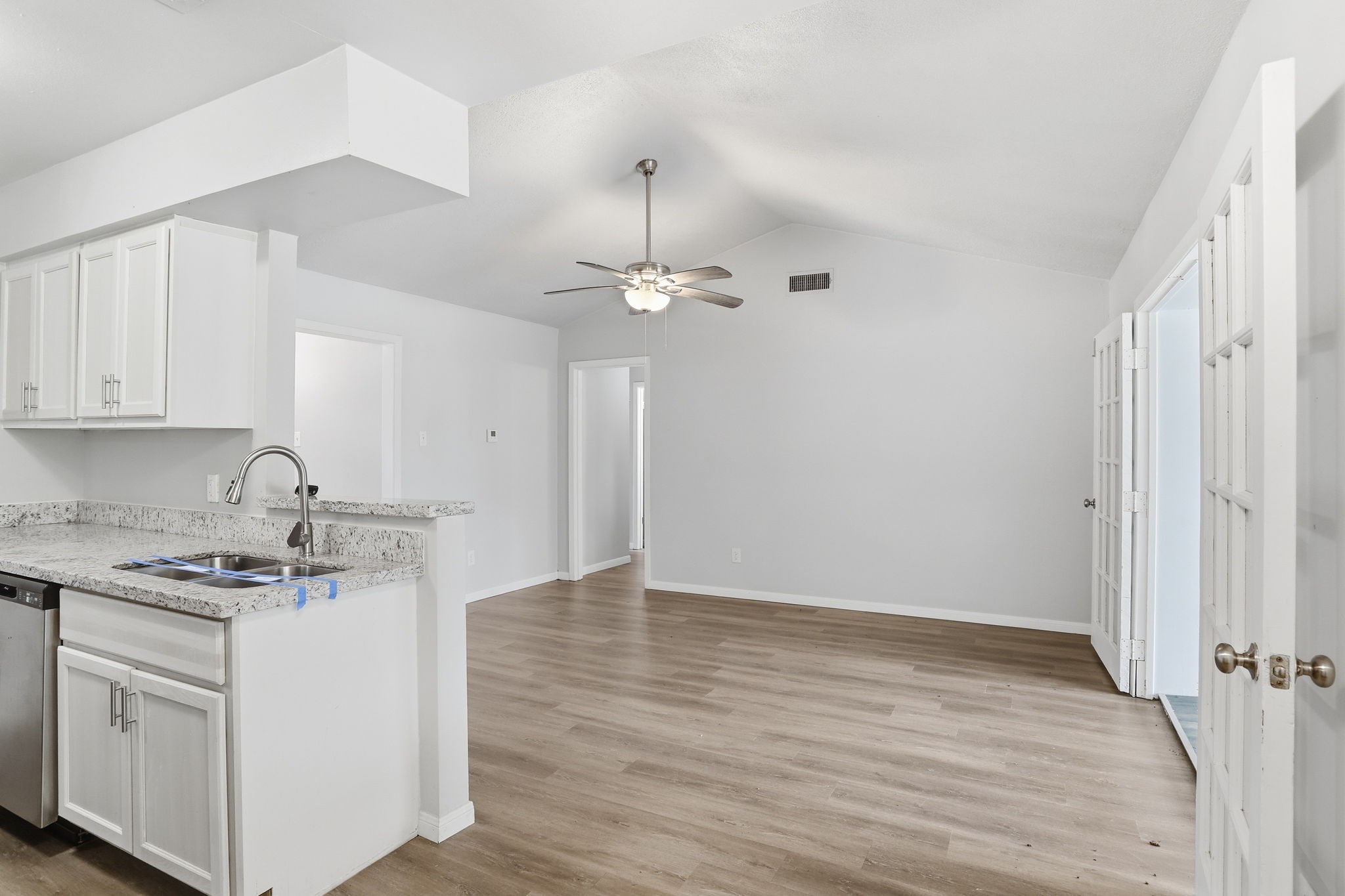 5242 Grace Point Lane Houston, TX 77048 - Photo 15 of 38 a kitchen with a sink cabinets and wooden floor