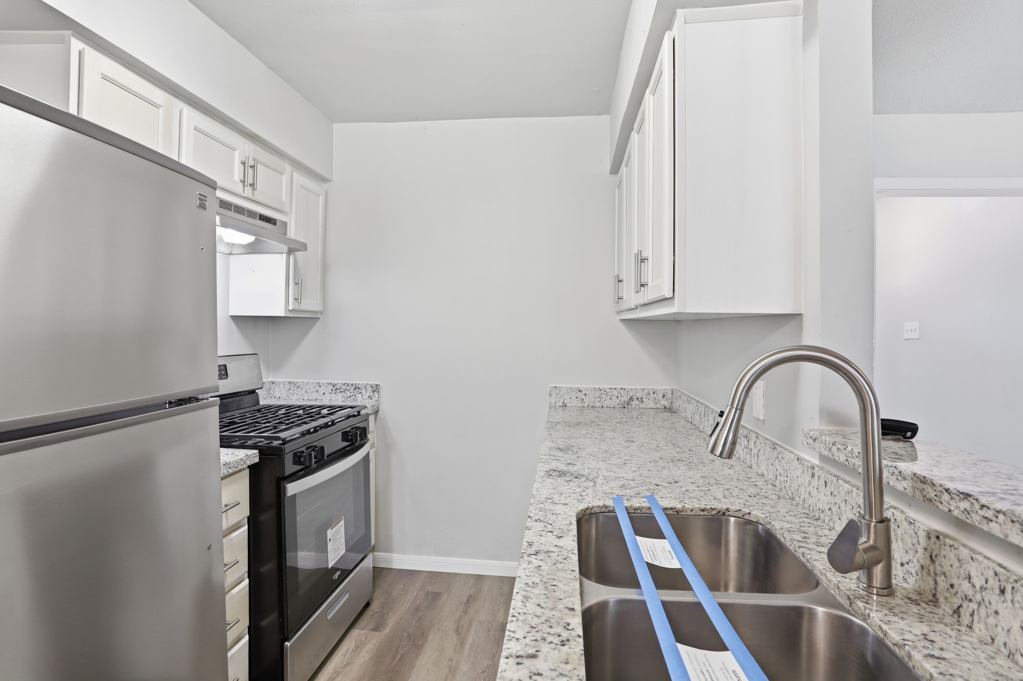 5242 Grace Point Lane Houston, TX 77048 - Photo 16 of 38 a kitchen with granite countertop a stove and a sink