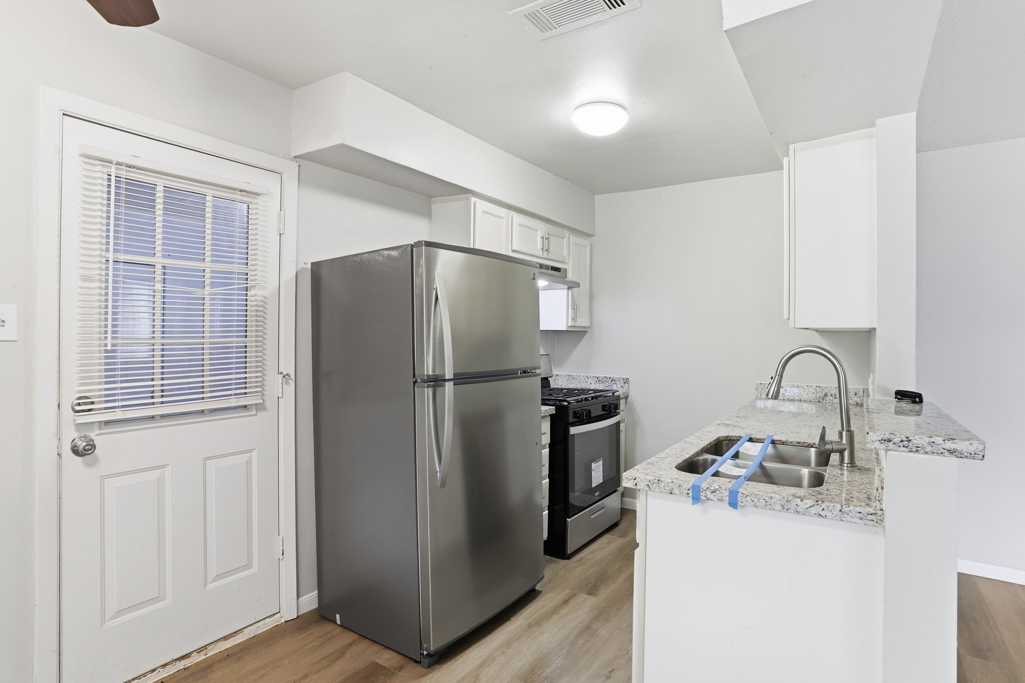 5242 Grace Point Lane Houston, TX 77048 - Photo 18 of 38 a kitchen with a refrigerator and a sink