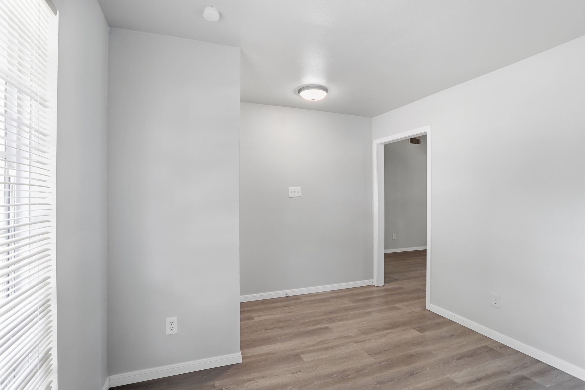 5242 Grace Point Lane Houston, TX 77048 - Photo 19 of 38 a view of an empty room with wooden floor and a window