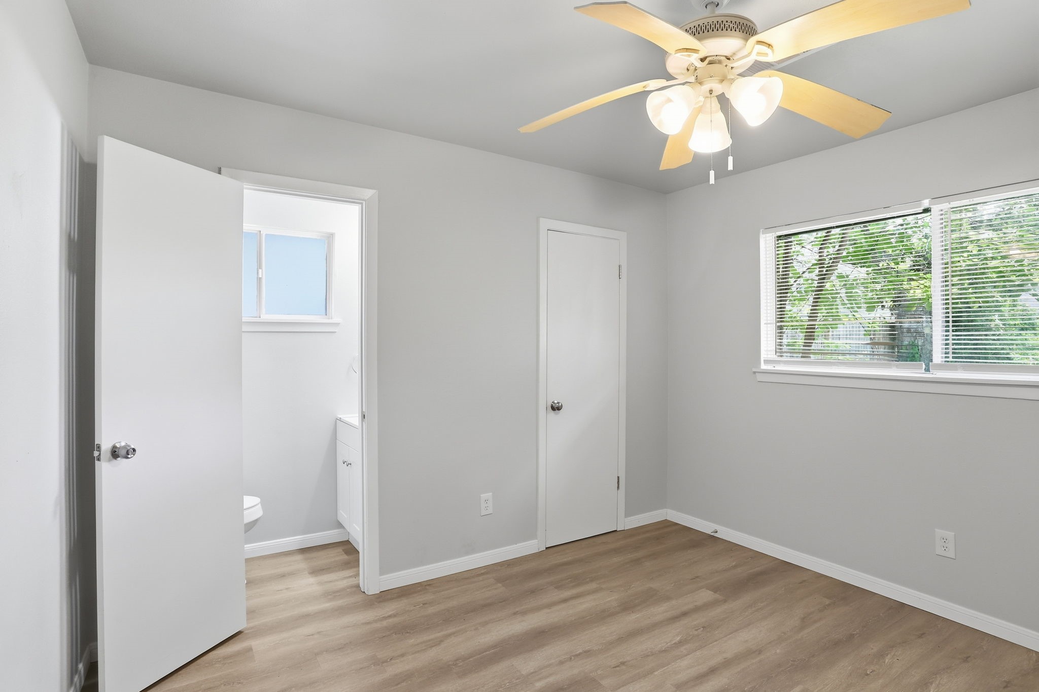 5242 Grace Point Lane Houston, TX 77048 - Photo 20 of 38 an empty room with wooden floor fan and windows