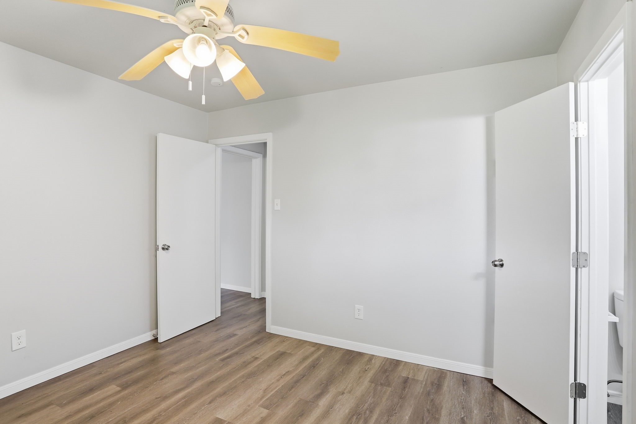 5242 Grace Point Lane Houston, TX 77048 - Photo 22 of 38 an empty room with wooden floor fan and windows