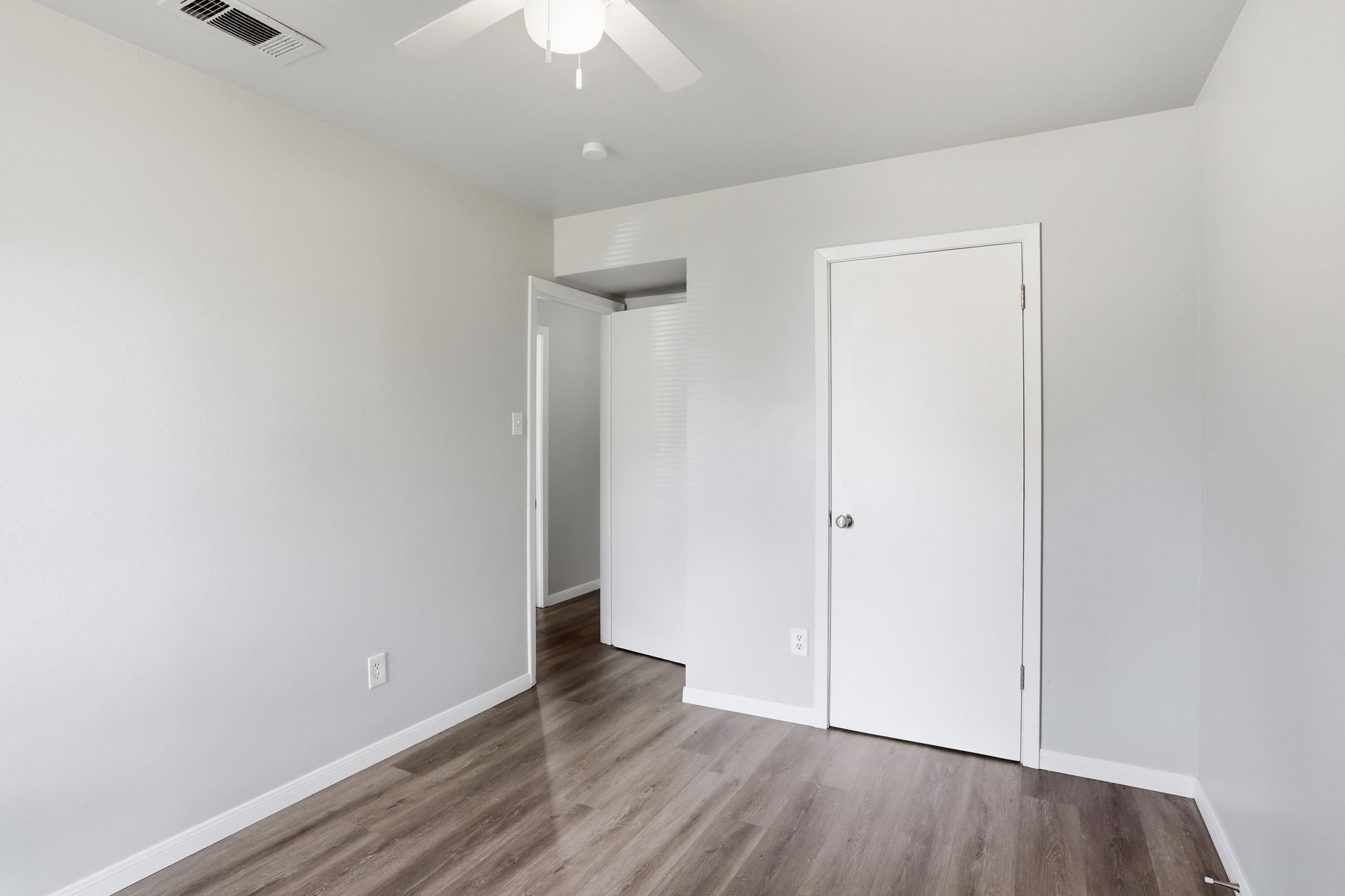 5242 Grace Point Lane Houston, TX 77048 - Photo 24 of 38 an empty room with wooden floor and a ceiling fan