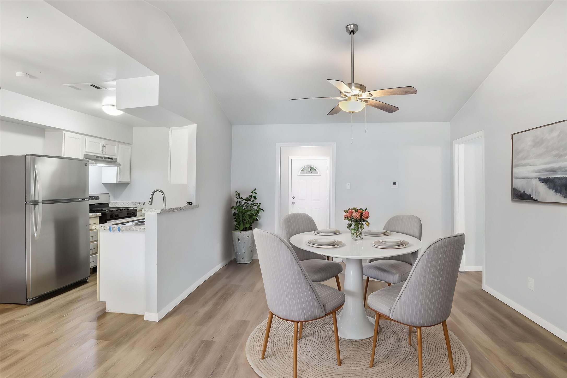 5242 Grace Point Lane Houston, TX 77048 - Photo 3 of 38 a view of a dining room with furniture wooden floor a chandelier
