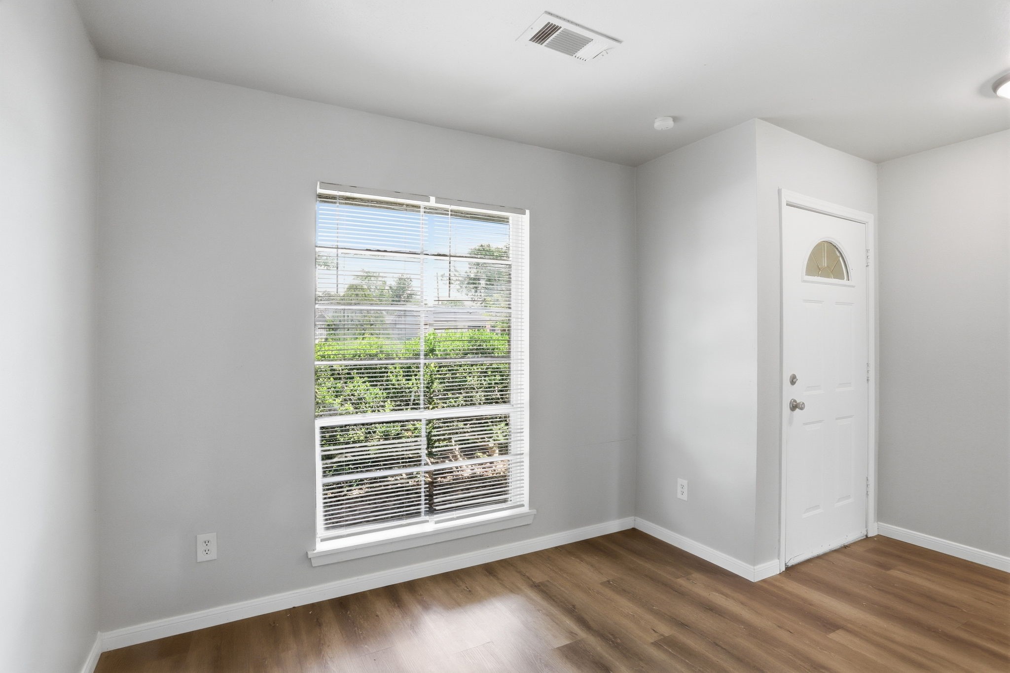 5242 Grace Point Lane Houston, TX 77048 - Photo 8 of 38 an empty room with wooden floor and windows