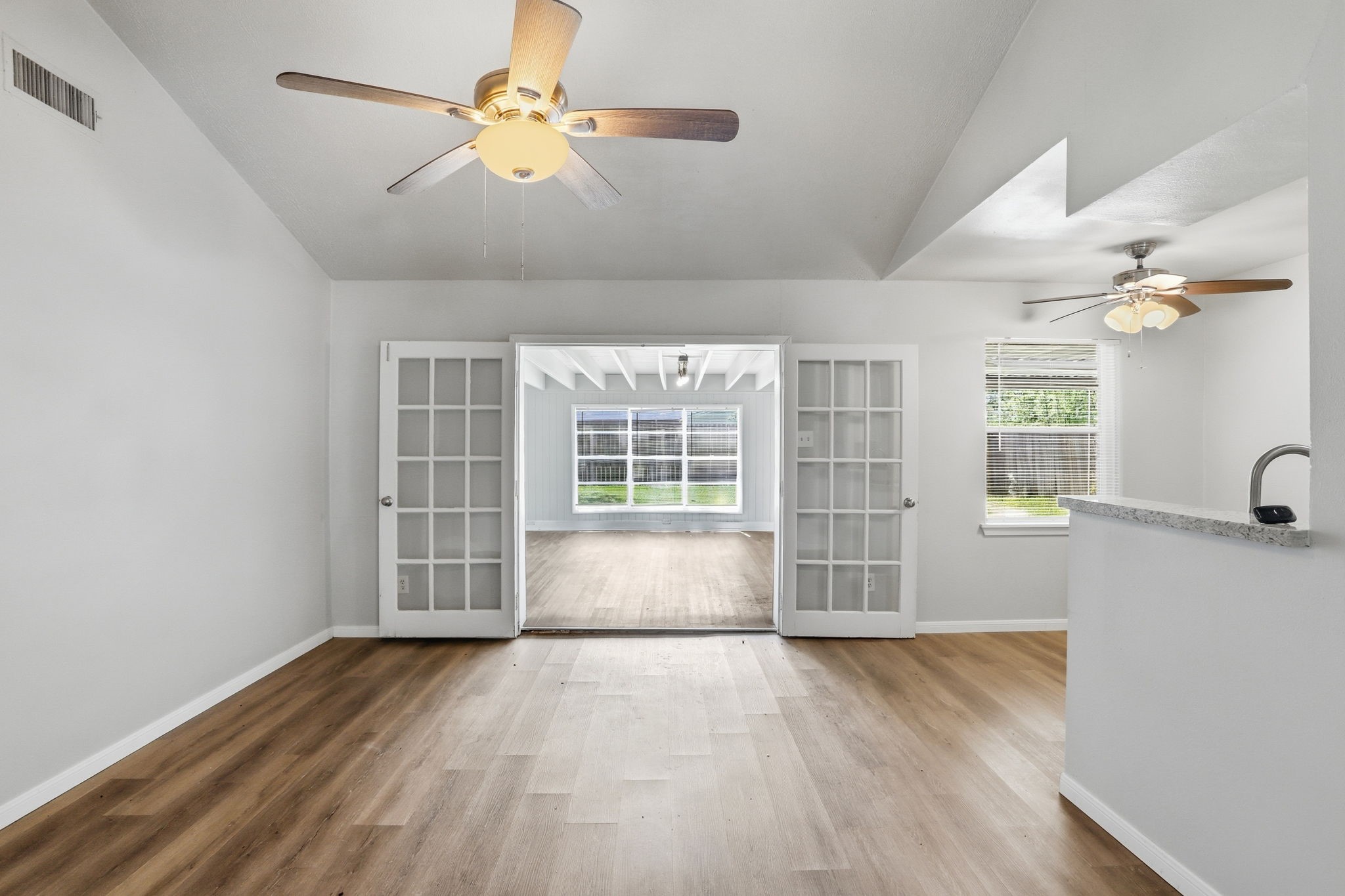 5242 Grace Point Lane Houston, TX 77048 - Photo 9 of 38 a view of an empty room with a window and wooden floor