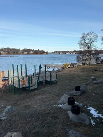 a view of a lake with houses in the background