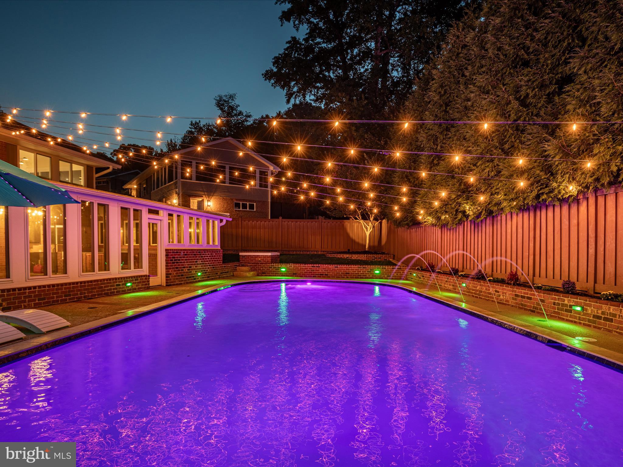 a view of swimming pool with outdoor seating and yard in the back