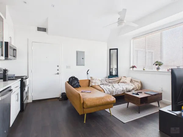 a living room with furniture and wooden floor