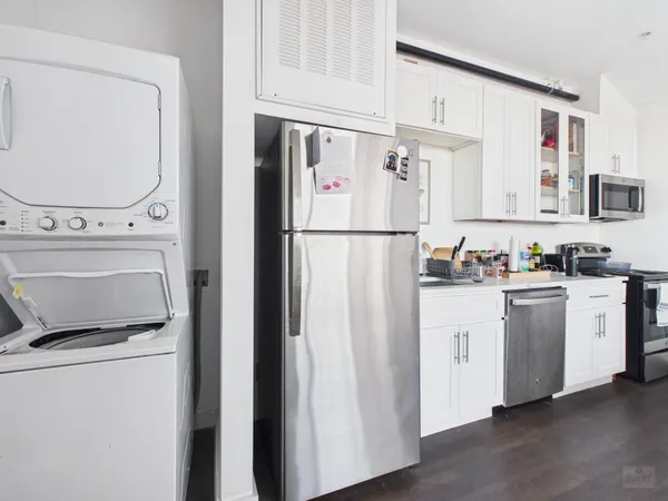 a white refrigerator freezer sitting in a kitchen
