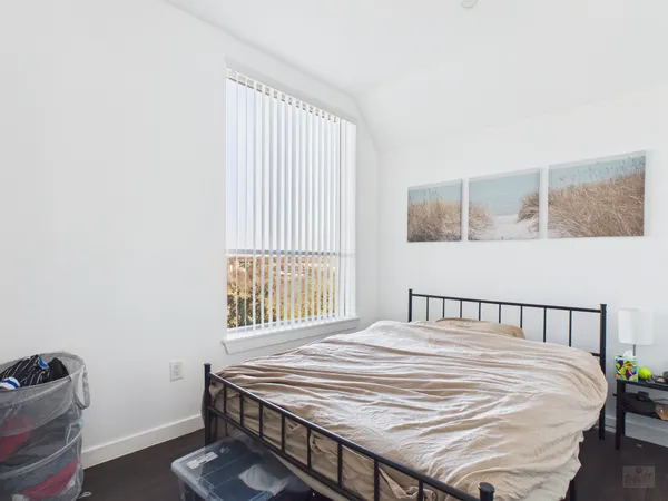 a bedroom with a bed and a window