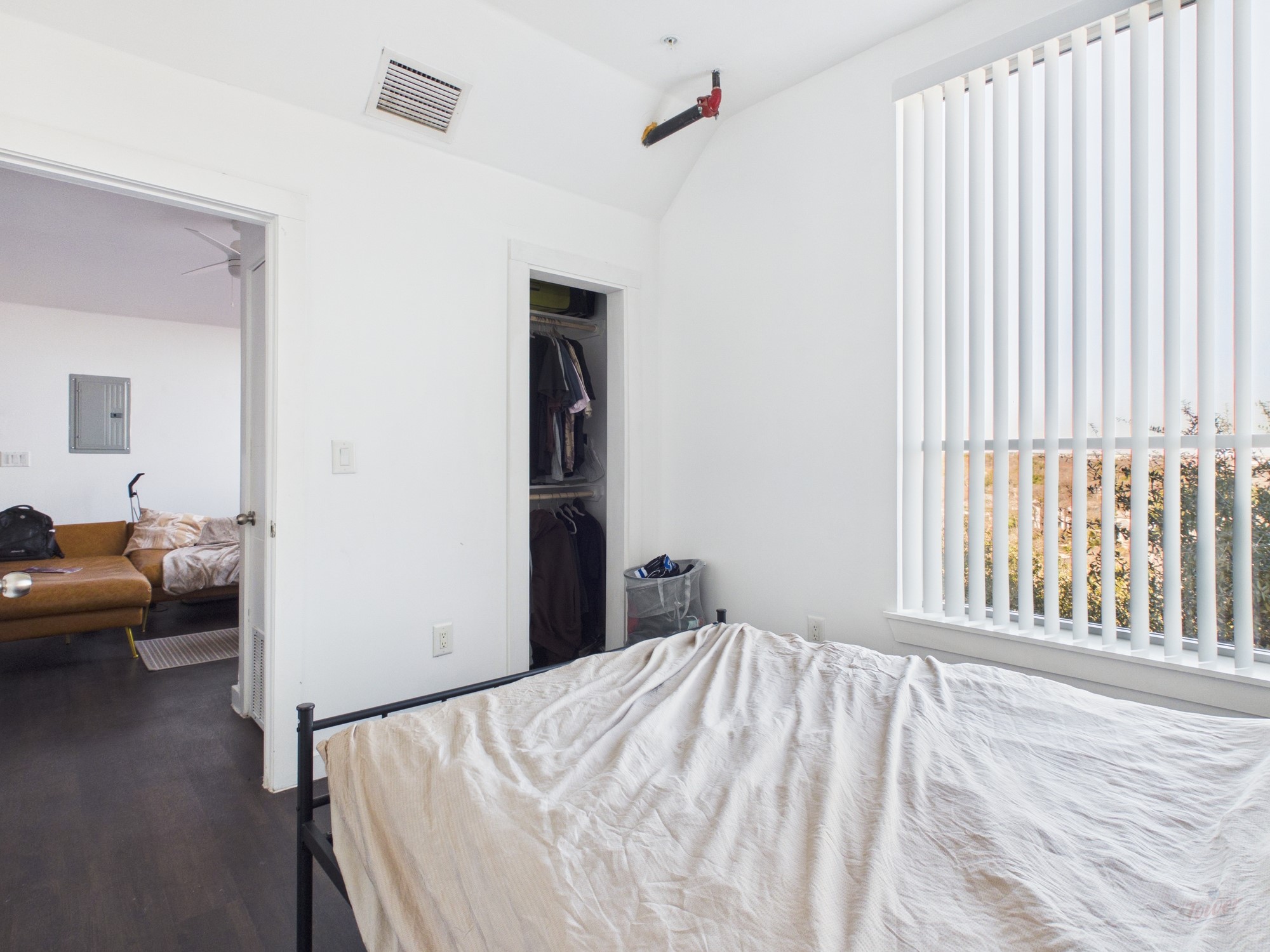 1010 West 26th Street, Unit 201 Austin, TX 78705 - Photo 6 of 8 a bedroom with a bed and a couch