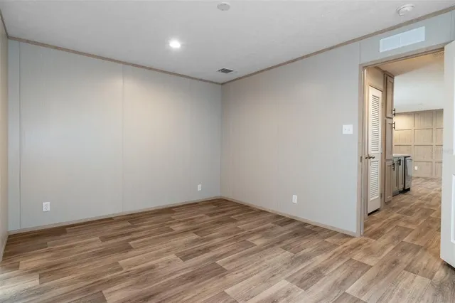 a view of a room with wooden floor