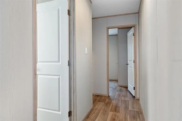 a view of a room with wooden floor